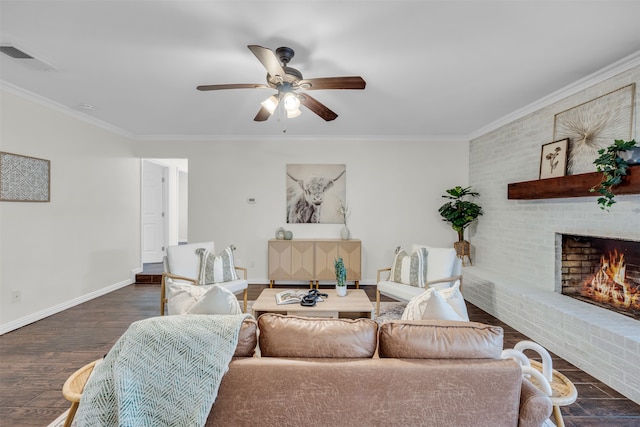 living room featuring a fireplace, ornamental molding, ceiling fan, and dark wood-type flooring