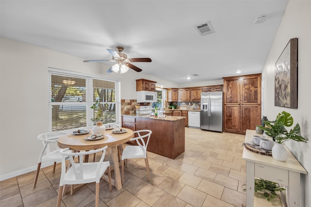 kitchen with backsplash, ceiling fan, and white appliances