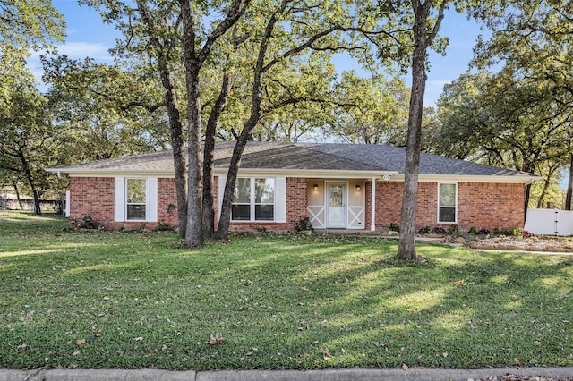 ranch-style home featuring a front yard