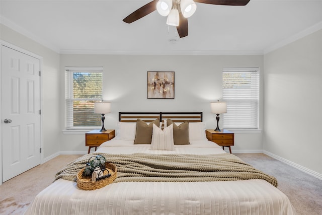 carpeted bedroom with multiple windows, ornamental molding, and ceiling fan