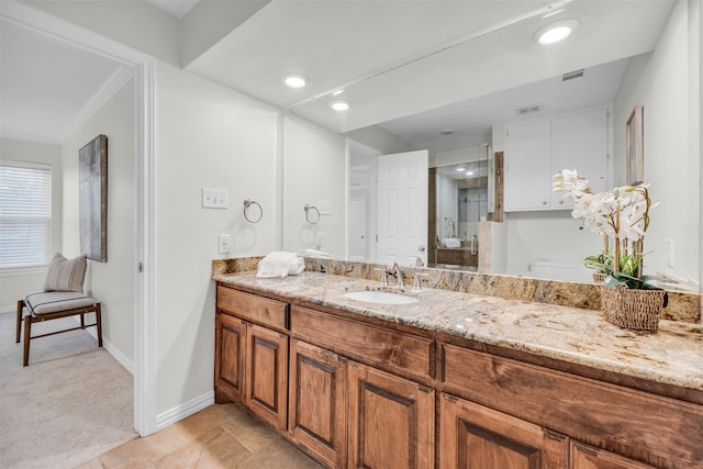 bathroom featuring tile patterned floors, vanity, an enclosed shower, and ornamental molding