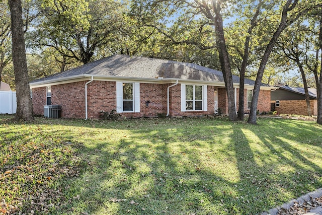 single story home featuring a front lawn and cooling unit