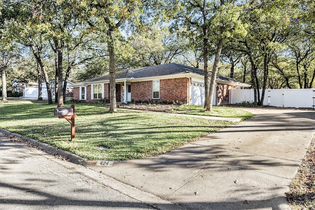 ranch-style home featuring a front yard and a garage