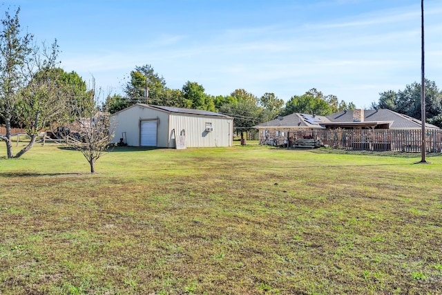 view of yard featuring a garage and an outdoor structure