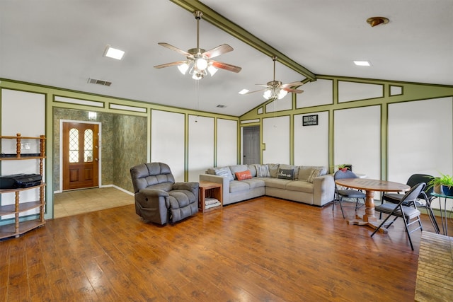 living room featuring hardwood / wood-style floors, vaulted ceiling with beams, and ceiling fan