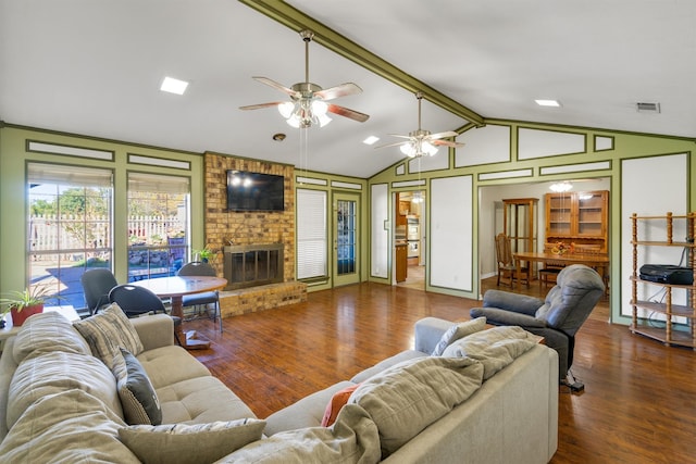 living room with dark hardwood / wood-style floors, ceiling fan, a fireplace, and vaulted ceiling