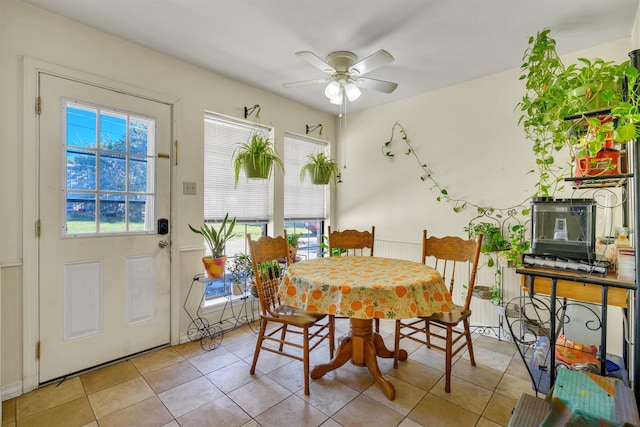 dining room with light tile patterned floors and ceiling fan