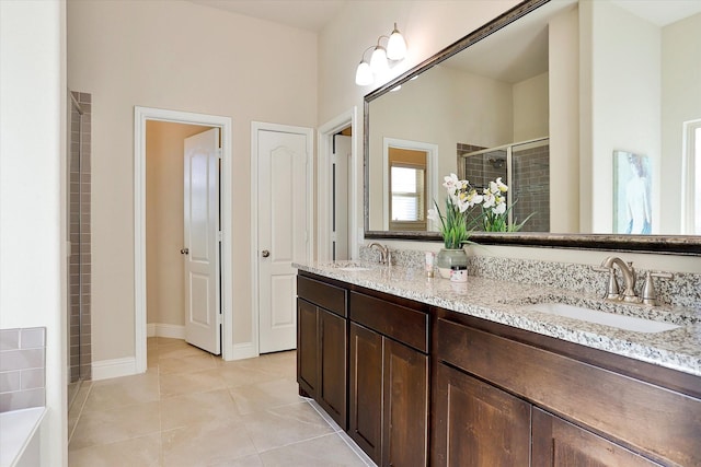 bathroom featuring vanity, tile patterned floors, and a shower with shower door