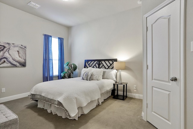 bedroom featuring light carpet