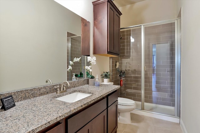 bathroom with toilet, vanity, tile patterned floors, and walk in shower