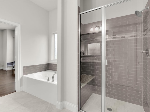 bathroom featuring hardwood / wood-style floors and plus walk in shower