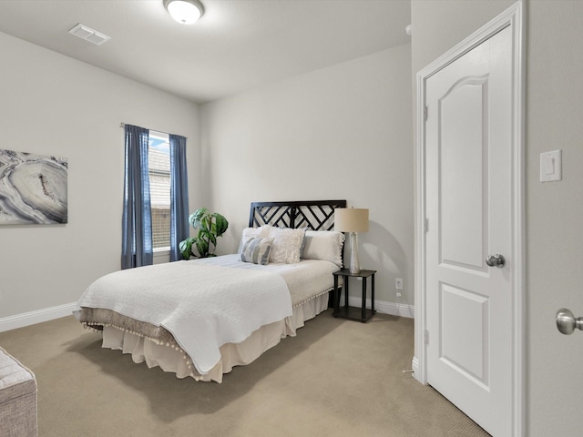 bedroom featuring light colored carpet