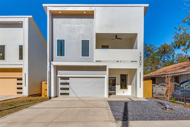 contemporary home featuring ceiling fan and a garage