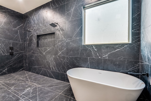 bathroom featuring shower with separate bathtub and tile walls