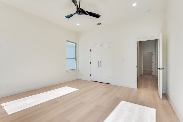 unfurnished bedroom with ceiling fan and light wood-type flooring