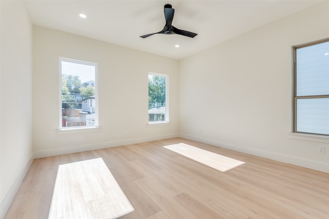 spare room with ceiling fan and light wood-type flooring