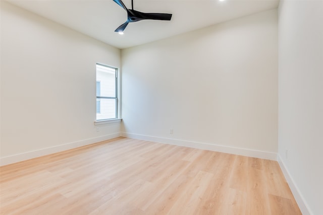 spare room with ceiling fan and light wood-type flooring