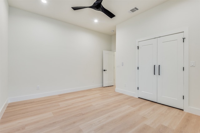 unfurnished bedroom with ceiling fan, a closet, and light hardwood / wood-style floors