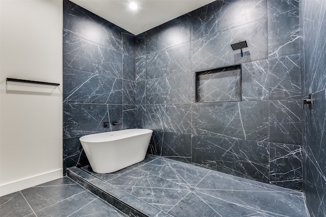 bathroom featuring plus walk in shower and tile walls