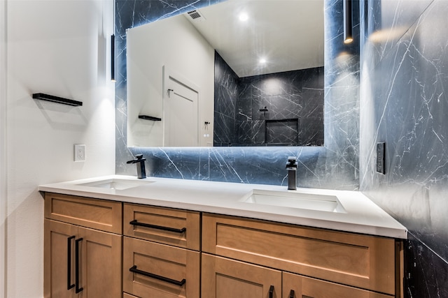 bathroom featuring vanity, tile walls, and backsplash