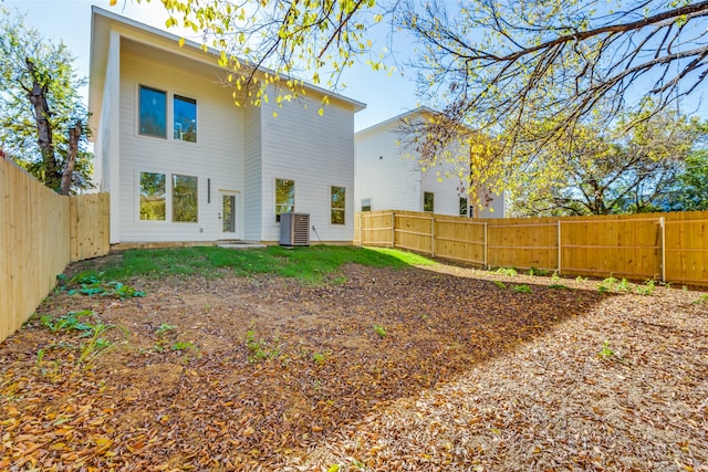 rear view of property with central AC unit