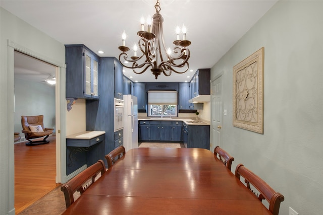 dining area featuring hardwood / wood-style floors and a notable chandelier