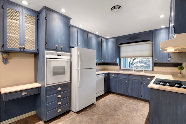 kitchen featuring blue cabinetry, white appliances, and sink