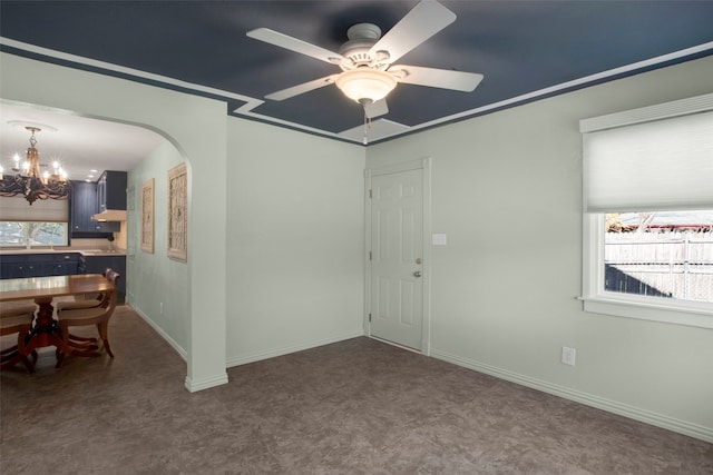 unfurnished room featuring ceiling fan with notable chandelier