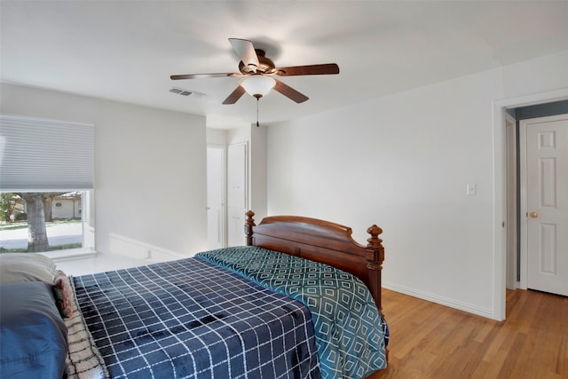 bedroom with ceiling fan and wood-type flooring