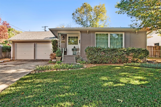 ranch-style home featuring a garage and a front lawn