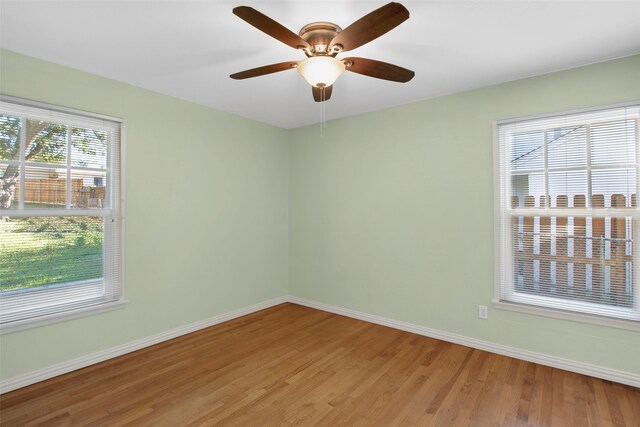 empty room with hardwood / wood-style flooring and ceiling fan