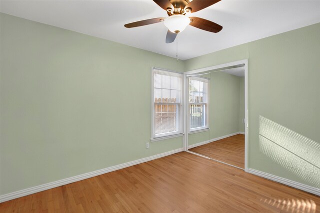 empty room with ceiling fan and hardwood / wood-style flooring