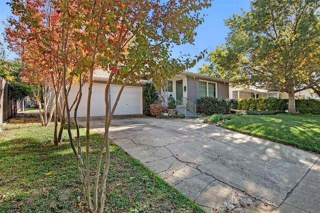 view of front of home with a garage and a front yard