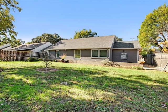 back of property featuring a lawn