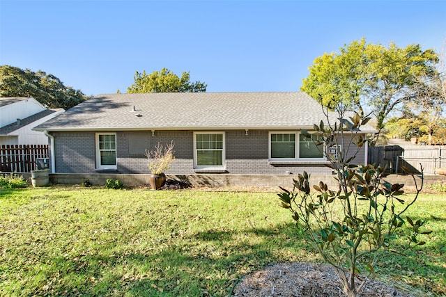 rear view of house with a yard