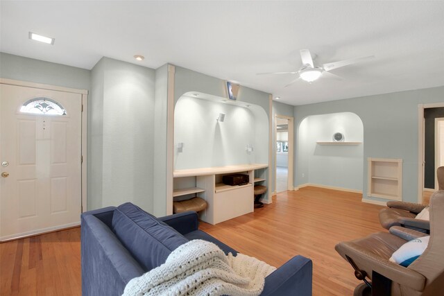 living room featuring ceiling fan and light hardwood / wood-style floors