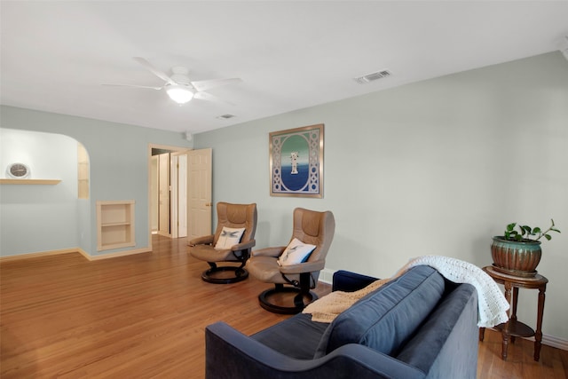 sitting room with ceiling fan and light hardwood / wood-style flooring