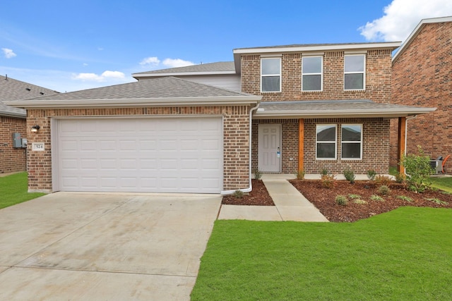 view of front of house with a garage and a front yard