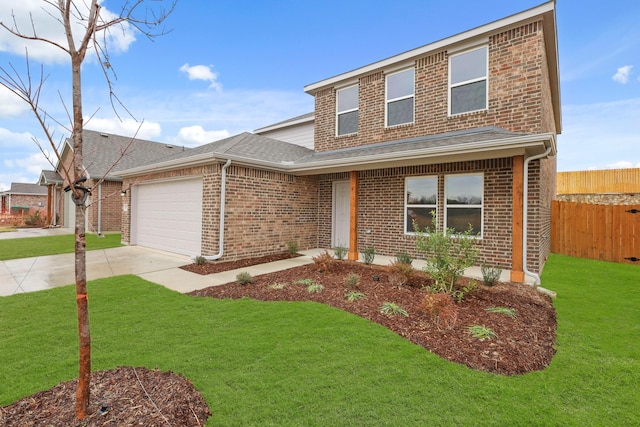 view of front of home with a garage and a front lawn