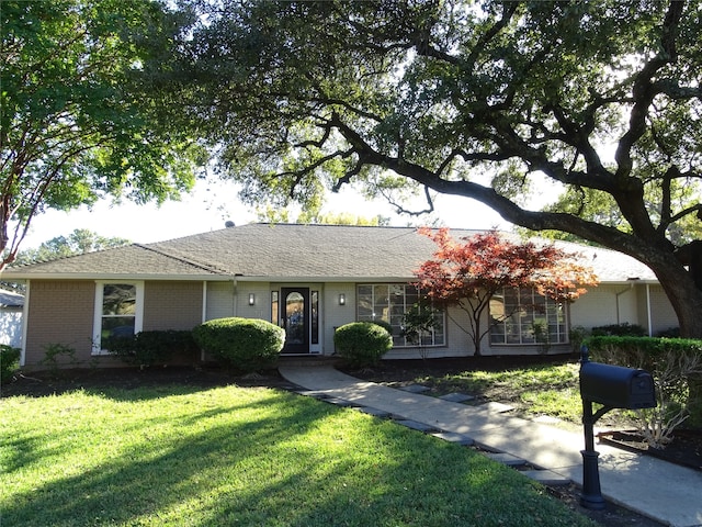 ranch-style home with a front yard