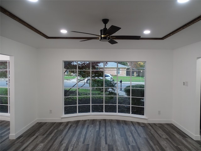 empty room featuring dark hardwood / wood-style floors, ceiling fan, and crown molding