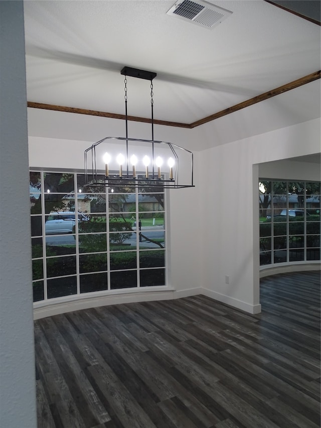 unfurnished dining area with a chandelier, dark hardwood / wood-style flooring, and ornamental molding