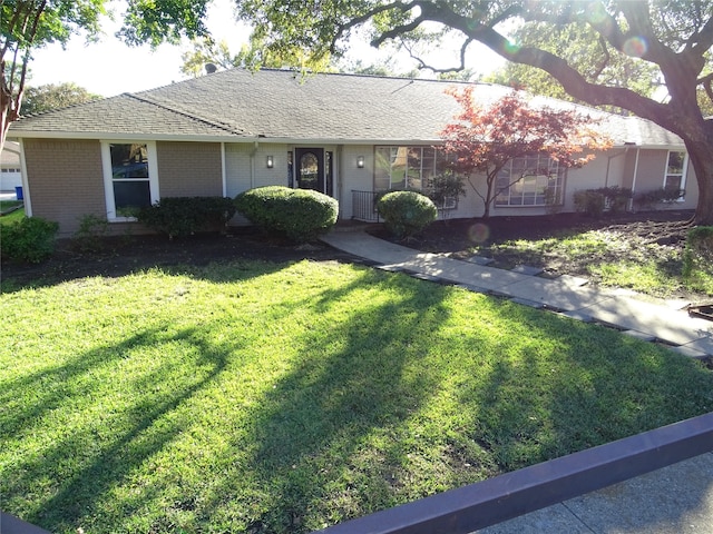 ranch-style home with a front lawn