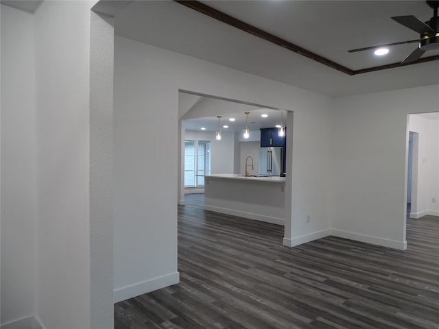 spare room with dark hardwood / wood-style floors, ceiling fan, and sink