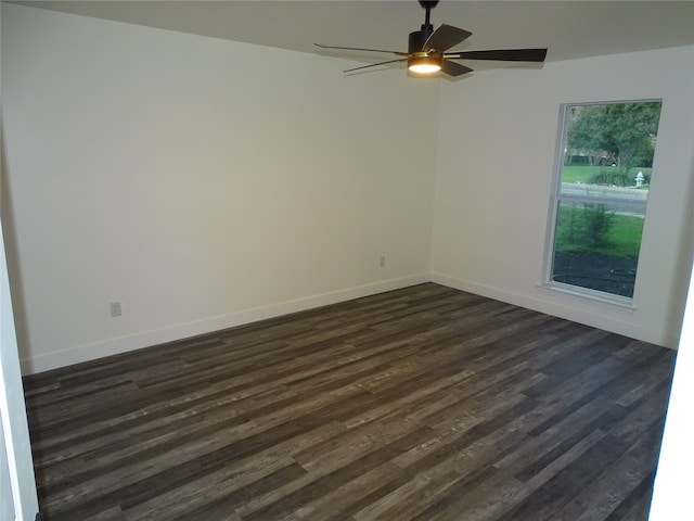 empty room with dark hardwood / wood-style floors and ceiling fan