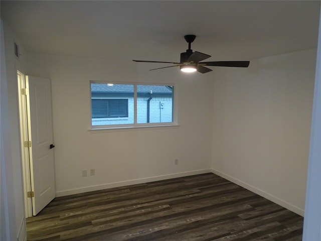 unfurnished room with ceiling fan and dark wood-type flooring