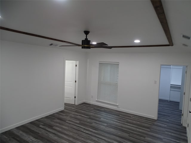 empty room with dark hardwood / wood-style flooring and ceiling fan