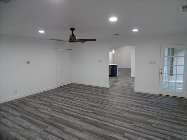 unfurnished room featuring ceiling fan and dark wood-type flooring