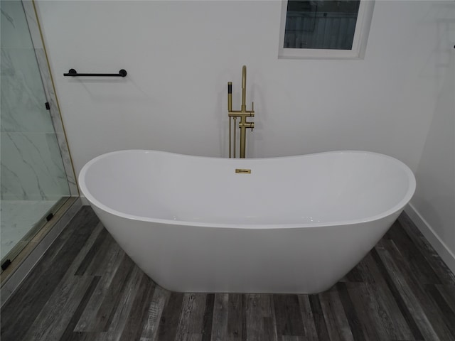 bathroom with hardwood / wood-style floors and a bathtub