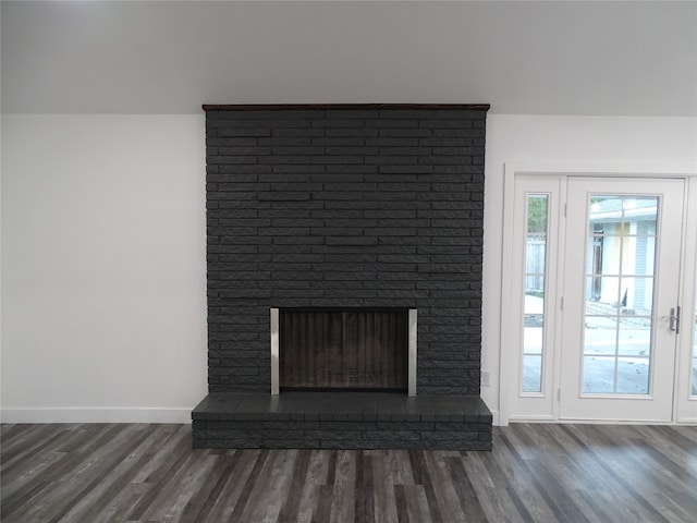 interior details with hardwood / wood-style flooring and a brick fireplace